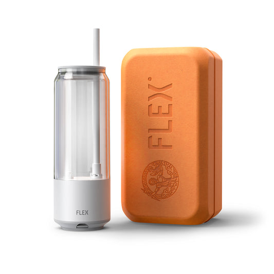 The FLEX CLEAR CAN, a sleek, transparent beverage container with a straw, stands next to its companion, the FLEX packaging. The packaging is a warm, earth-toned box embossed with the 'FLEX' logo and a detailed Greek-inspired emblem, conveying a sense of heritage and quality. This image represents the product's unboxing experience, emphasizing the premium and thoughtful packaging that complements the innovative design of the FLEX CLEAR CAN.
