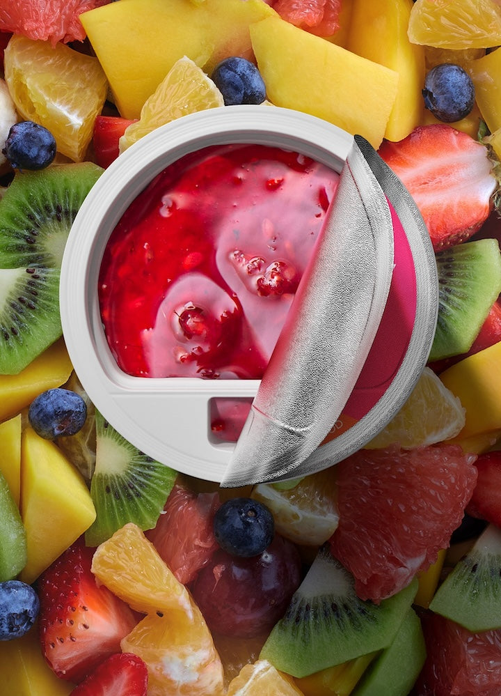 A vibrant blend of fruit flavors captured in a filter, surrounded by fresh cut slices of mango, kiwi, strawberry, blueberry, and citrus, embodying the fresh and natural essence of FLEX’s fruit-infused beverage selections.
